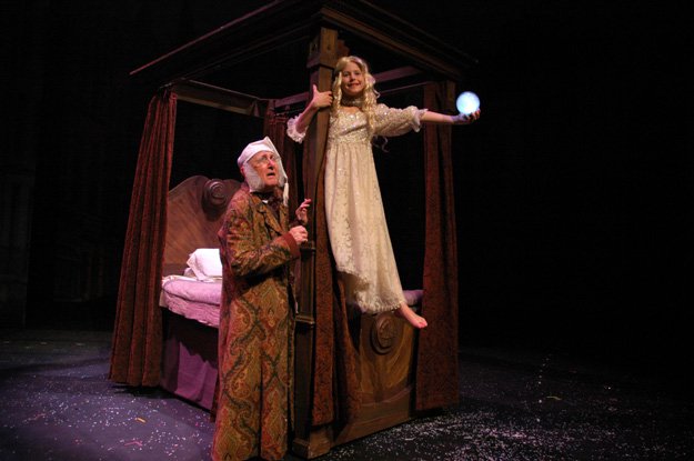 Scrooge and Past: Barry Fuller (l) as Scrooge and Alessandra as Ghost of Christmas Past in a recent production of  A Christmas Carol at Theatre Memphis